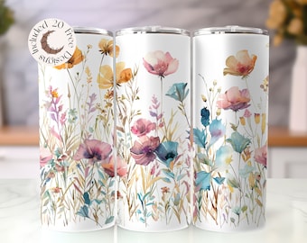 May include: Three white stainless steel tumblers with a watercolor floral design. The design features pink, blue, and yellow flowers with green stems and leaves. The tumblers are perfect for holding hot or cold beverages.