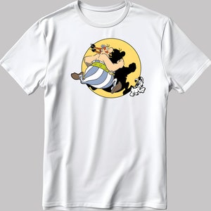 May include: White t-shirt featuring a cartoon image of a man with a red beard and a dog running in front of a yellow sun.