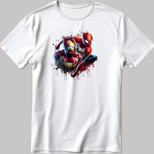 May include: White t-shirt featuring a colourful graphic print of Iron Man and Spider-Man in a dynamic pose. The design has a watercolour effect with splashes of red, blue, and yellow.
