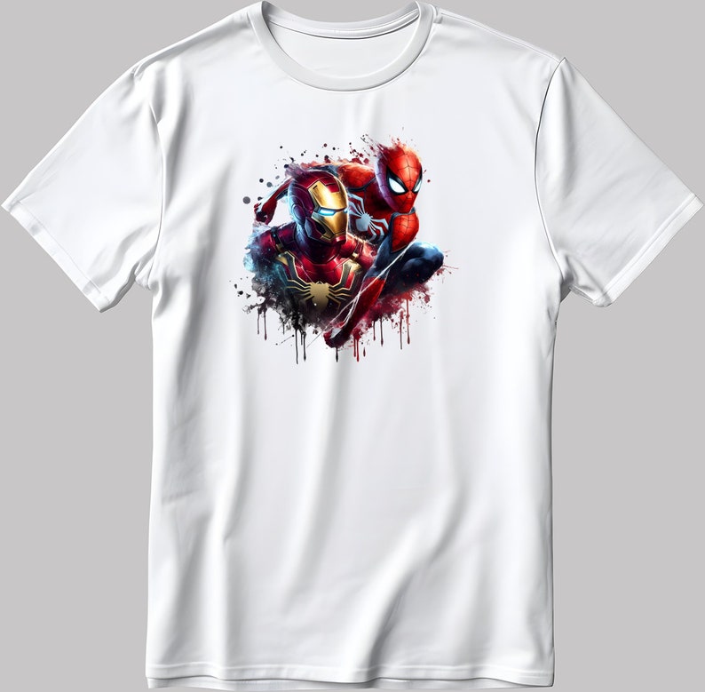 May include: White t-shirt featuring a colourful graphic print of Iron Man and Spider-Man in a dynamic pose. The design has a watercolour effect with splashes of red, blue, and yellow.