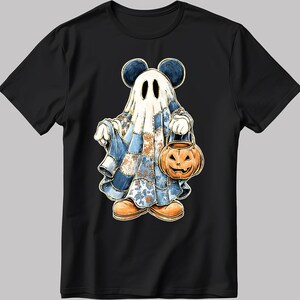 May include: Black t-shirt with a cartoon ghost character wearing Mickey Mouse ears. The ghost is dressed in a patchwork quilt and carries a jack-o'-lantern. The design has a Halloween theme with a vintage, hand-drawn style.