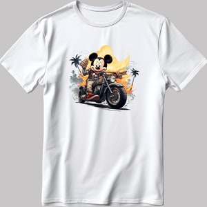 May include: White t-shirt featuring a cartoon image of Mickey Mouse riding a motorbike in a desert setting with palm trees.