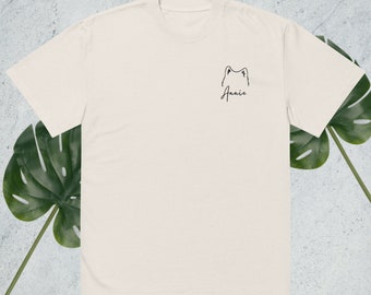 May include: A white t-shirt with a black line drawing of a dog's head and the name "Annie" written underneath. The shirt is a faded bone color.