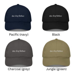 May include: Four baseball caps in navy, black, grey, and green. Each cap has the text "the dog father" embroidered on the front. The navy cap is labeled "Pacific", the black cap is labeled "Black", the grey cap is labeled "Charcoal", and the green cap is labeled "Jungle".
