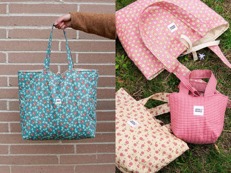 A collection of quilted tote bags in various sizes and patterns. One large teal bag with a floral print is held up. Other bags include pink and cream floral patterns, and a small pink gingham bag. Each bag has a small white label.