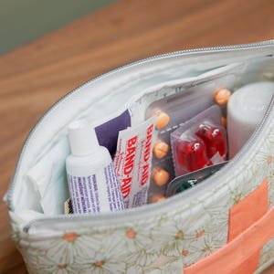 An open zipper bag showing medicine inside.