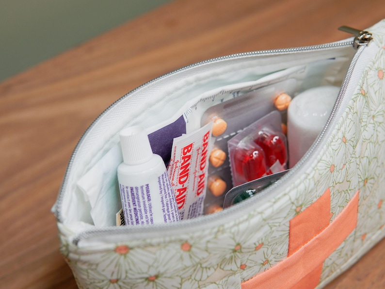 An open zipper bag showing medicine inside.