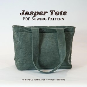 May include: A teal green tote bag with two handles and a rectangular shape. The text "Jasper Tote PDF Sewing Pattern" is displayed above the bag. Below the bag, the text reads "Printable Templates + Video Tutorial".