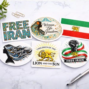 May include: A collection of stickers with various designs and text. One sticker reads "FREE IRAN" in teal and gold. Other stickers feature a woman's silhouette, the text "Woman Life Freedom", and a fist with the Iranian flag.