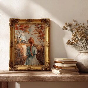May include: A framed painting with a gold ornate frame depicts a woman with red hair walking on a path towards a house. The artwork is set in an autumn landscape with trees and a field. A stack of books and a vase with dried flowers are on a wooden shelf.
