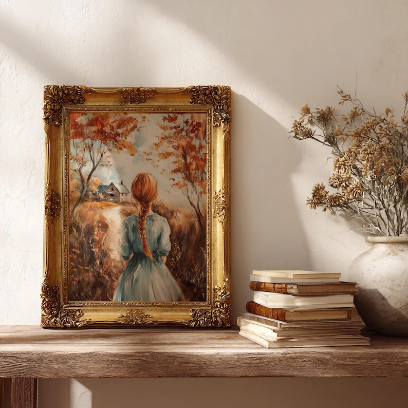 May include: A framed painting with a gold ornate frame depicts a woman with red hair walking on a path towards a house. The artwork is set in an autumn landscape with trees and a field. A stack of books and a vase with dried flowers are on a wooden shelf.