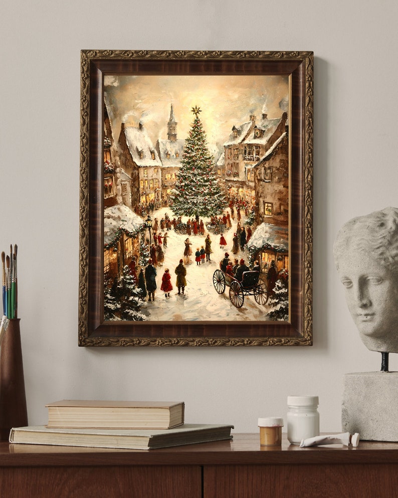 May include: A framed painting depicts a snowy Christmas scene in a European village. The artwork features a large Christmas tree, horse-drawn carriage, and figures in winter attire. The frame is a dark brown with ornate detailing.