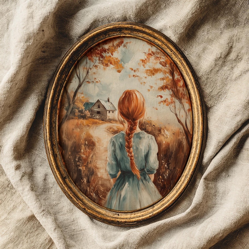 May include: Oval framed painting featuring a woman with red hair in a blue dress, facing away from the viewer. The painting depicts a path leading to a house, surrounded by trees with autumn foliage. The frame is gold.