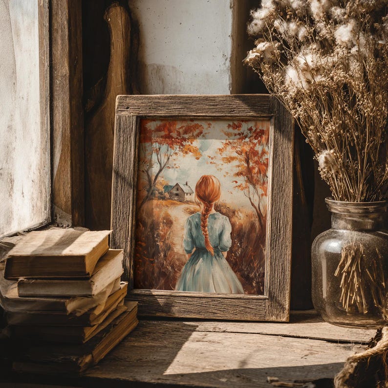 May include: A framed watercolor painting depicts a girl with red hair in a blue dress, walking away from the viewer on a path towards a house. The painting is in a rustic wooden frame, set on a wooden surface with old books and a glass jar with dried flowers.