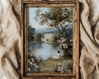 Puede incluir: Pintura de paisaje enmarcada que presenta una serena escena junto al agua. La obra de arte representa un edificio blanco al otro lado de un lago, con árboles, flores y una persona leyendo. El marco es de madera con un acabado cálido y natural.