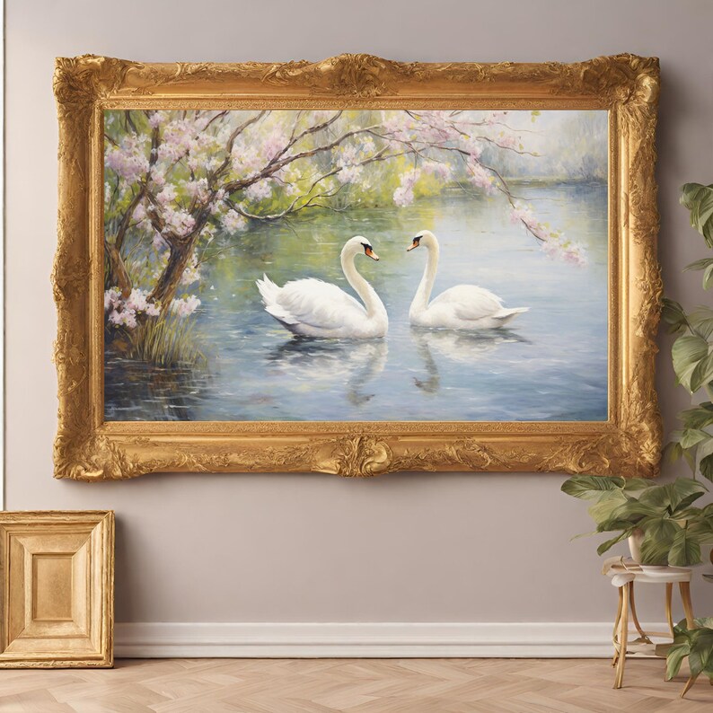 May include: A framed painting of two white swans swimming in a lake with a tree with white blossoms in the background.