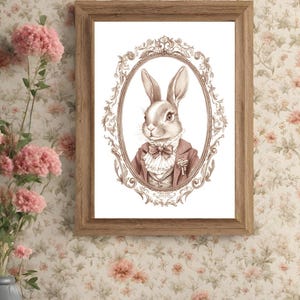 May include: A framed illustration of a rabbit wearing a suit and bow tie. The rabbit is in an ornate oval frame with a white background.