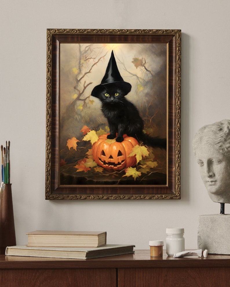 May include: A black cat wearing a witch's hat sits on top of a carved pumpkin. The cat has green eyes and is looking directly at the viewer. The pumpkin is orange and has a carved jack-o'-lantern face. The background is a dark forest scene with leaves on the ground.