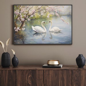 May include: A painting of two white swans swimming in a lake with a blooming tree in the background. The swans are facing each other and the water is a light blue color.