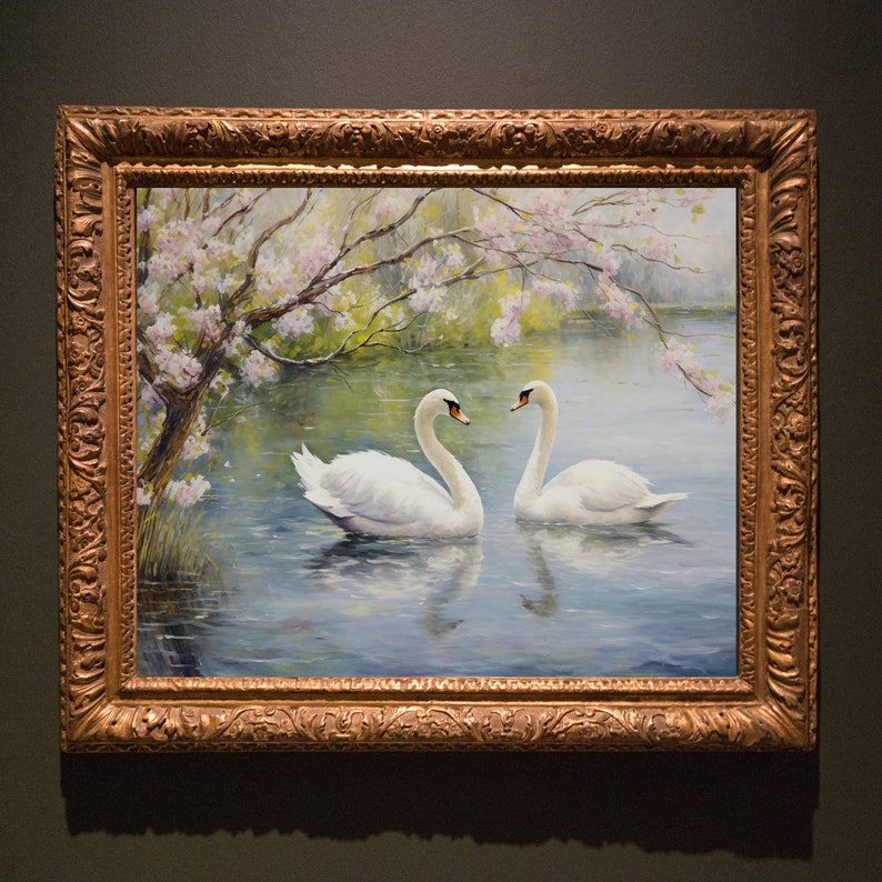 May include: A framed painting of two white swans swimming in a lake with a blooming tree in the background. The painting is in a gold frame with ornate details.