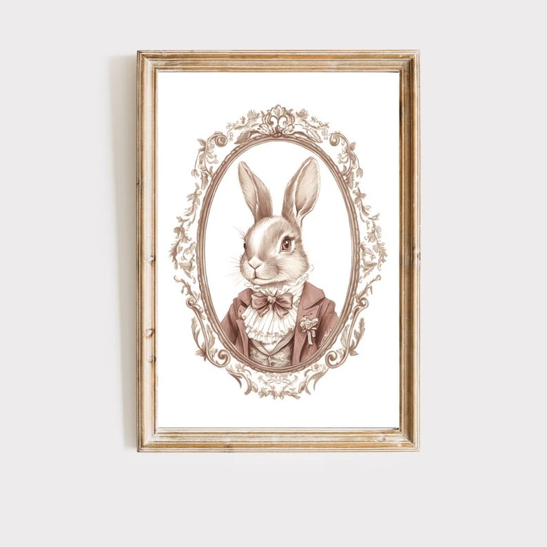 May include: A brown rabbit wearing a pink jacket and a white bow tie is depicted in a vintage-style oval frame with ornate details. The rabbit has a white patch on its nose and is looking to the left.