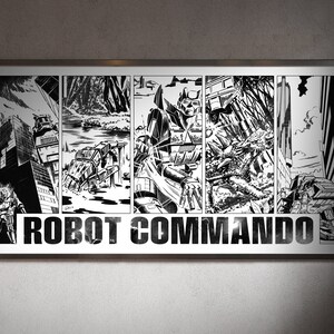 May include: A framed black and white comic strip titled "Robot Commando." The artwork depicts robots and cityscapes in a dynamic, action-packed style. The title is prominently displayed in bold, block letters.