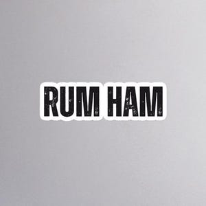 May include: Black and white text on a white background that reads "RUM HAM".