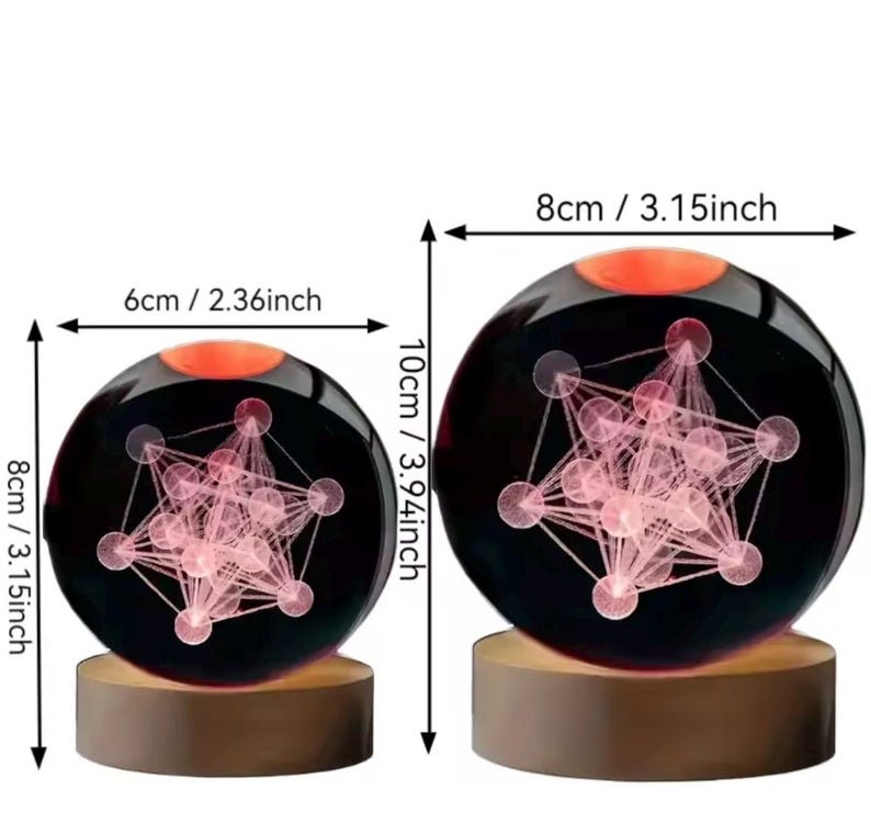 May include: Two spherical glass ornaments on cylindrical wooden bases, each containing a pink geometric star pattern. The smaller sphere measures 2.36 inches wide by 3.15 inches high, and the larger sphere measures 3.15 inches wide by 3.94 inches high.