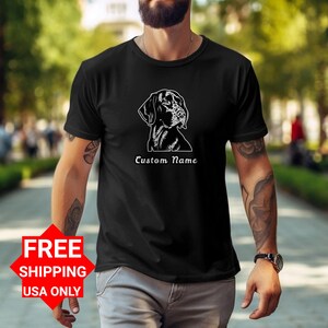 May include: Black t-shirt featuring a white outline of a German Shorthaired Pointer dog's head. The text "Custom Name" is printed below the dog's head.