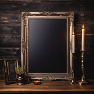 May include: A vintage-style, ornate gold frame with a black chalkboard insert. Two lit candles in gold candle holders are on a wooden surface in front of the frame.