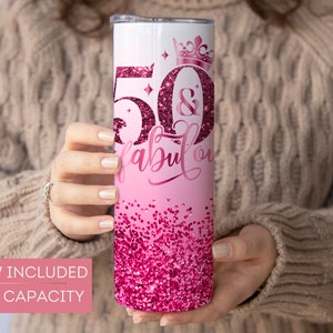 May include: Pink and white 20 ounce stainless steel tumbler with a glitter design and the text "50 & Fabulous" with a crown above the 50. Straw included.