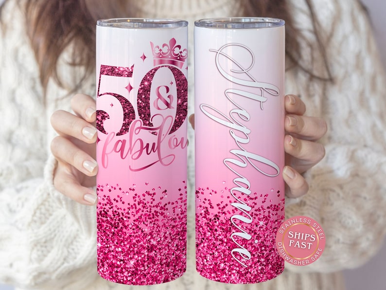 May include: Pink and white stainless steel tumbler with a pink glitter design. The tumbler has the text "50 & fabulous" and a crown on one side and the name "Stephanie" on the other side.