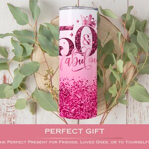 May include: Pink and white tumbler with a glitter design and the text "50 & fabulous" with a crown on top.