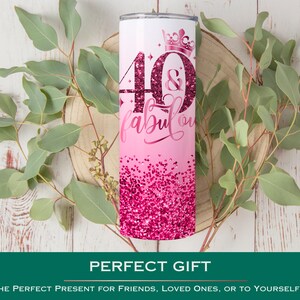 May include: Pink and white stainless steel tumbler with a glitter design and the text "40 & fabulous" with a crown above the 40.