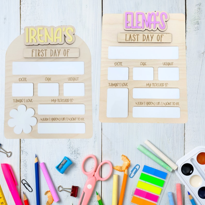 May include: Two wooden signs with blank spaces for writing. The signs are decorated with the words "Irena's First Day Of" and "Elena's Last Day Of". The signs are perfect for capturing memories of a child's first and last day of school.