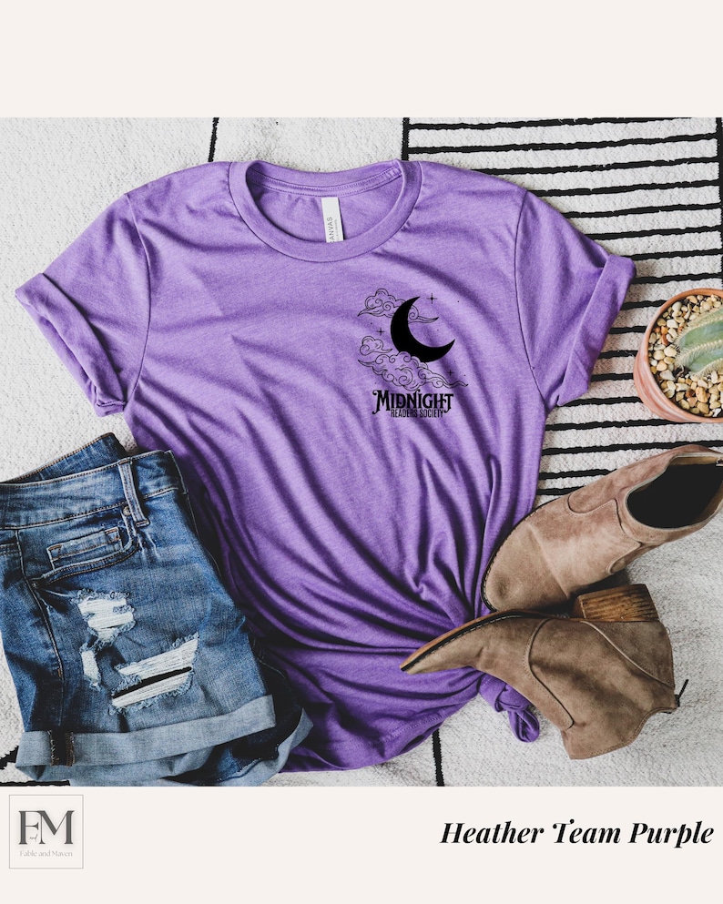 May include: A purple heather t-shirt with a black crescent moon and clouds graphic. The graphic also includes the text "Midnight Reading Society".
