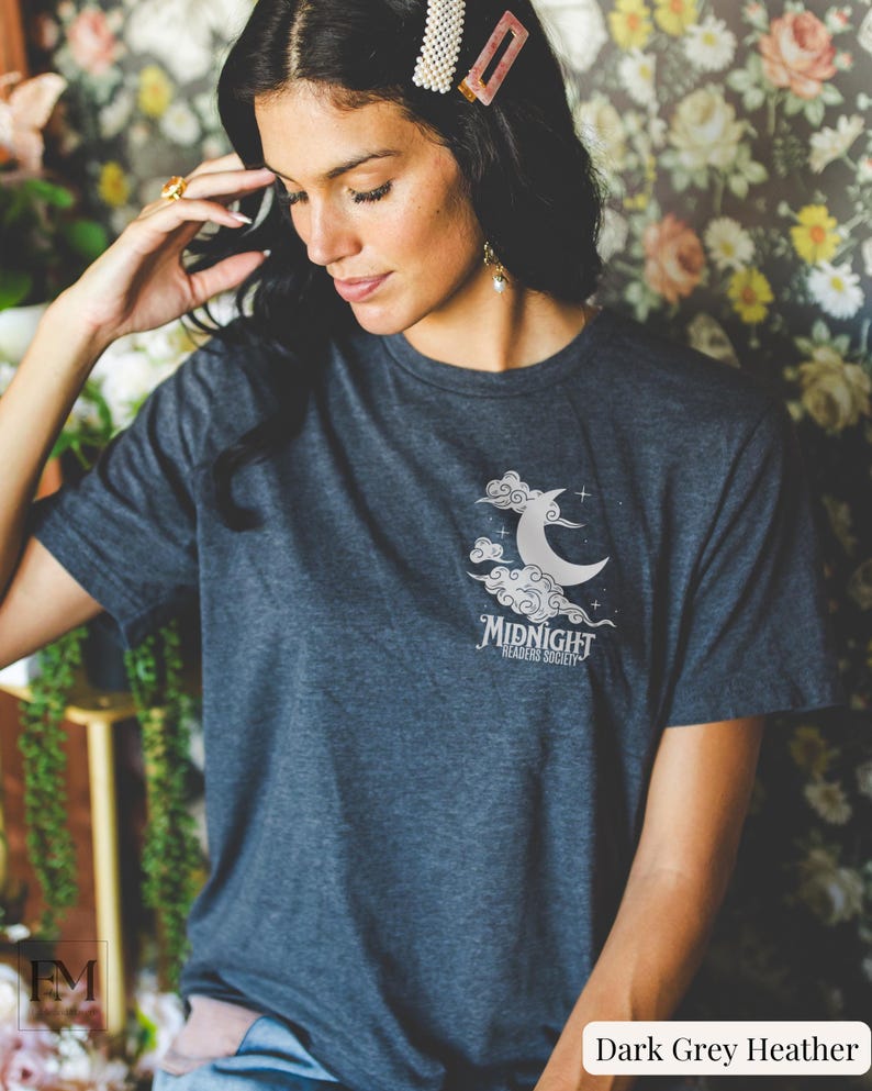 May include: Dark grey heather t-shirt with a white graphic of a crescent moon in clouds and the text "Midnight Readers Society".