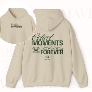 May include: A beige hooded sweatshirt with a green graphic print that says "Collect Moments Enjoy Now and Forever" and "Since 1916".