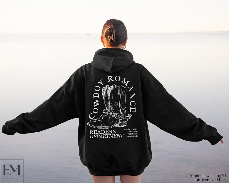 May include: Black hoodie with a white graphic print of cowboy boots and the text "Cowboy Romance Readers Department".