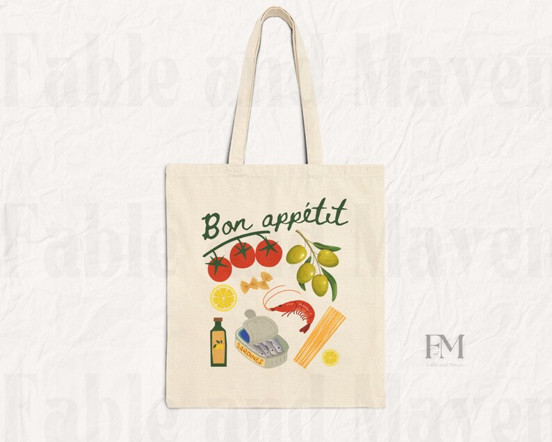 May include: A white canvas tote bag with the text "Bon app&eacute;tit" in green lettering. The bag features a colorful illustration of tomatoes, olives, lemons, pasta, sardines, and a shrimp.