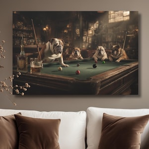 May include: A canvas print depicts four English bulldogs playing pool in a dimly lit pub. The dogs are positioned around a green felt pool table, with billiard balls and cues. The background features a bar and framed pictures.