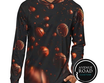 May include: A black long-sleeve hoodie with a basketball pattern. The hoodie has a drawstring hood and a kangaroo pocket. The basketballs are orange and brown and appear to be floating in mid-air. The text "AVENUE ROAD CUSTOM" is on a white circle with a gold laurel wreath.