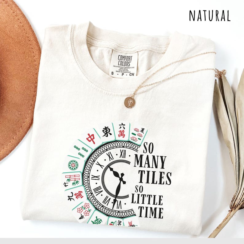 Natural comfort colors shirt with the phrase “So Many Tiles So Little Time” and colorful mahjong tiles surrounding a clock design, perfect for mahjong lovers and game night fans.