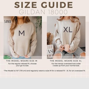 May include: A size guide for the Gildan 18000 sweatshirt in sand. The image displays two sand-colored crewneck sweatshirts, one labeled size M and one labeled size XL. Text includes SIZE GUIDE, GILDAN 18000, SAND, THE MODEL WEARS SIZE M, THE MODEL WEARS SIZE XL, and height 5'10".
