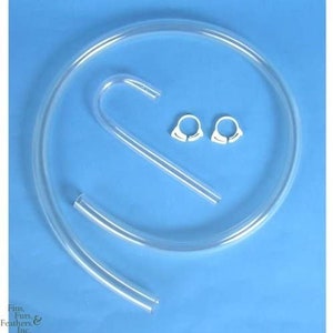 May include: A clear plastic aquarium siphon tube with two white plastic clamps. The tube is bent into a U-shape and has a long, straight section.