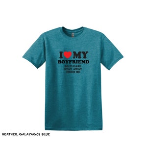 May include: A teal blue t-shirt with the text "I love my boyfriend so please stay away from me" and a red heart.