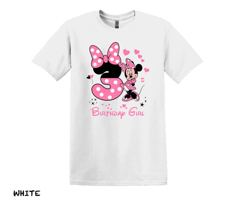 May include: White t-shirt with a pink Minnie Mouse graphic. Minnie is holding a pink number 3 with white polka dots. The text "Birthday Girl" is below the graphic.