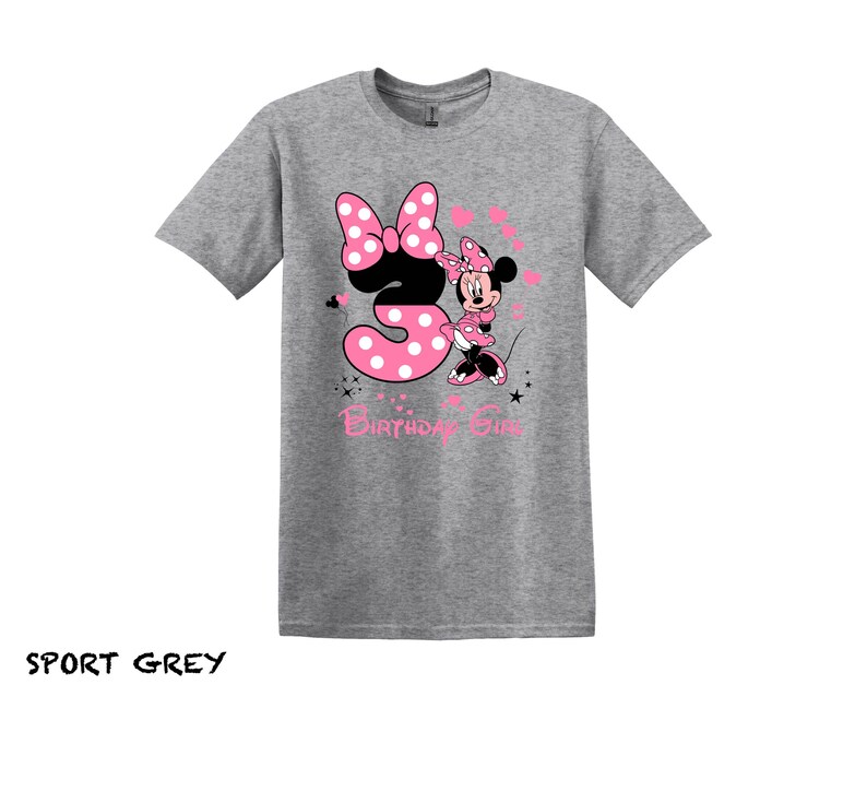 May include: A gray t-shirt with a pink and black Minnie Mouse graphic. The graphic shows Minnie Mouse holding a pink number 3 with white polka dots. The text "Birthday Girl" is below the graphic.