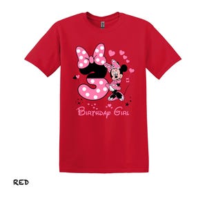 May include: Red t-shirt with a pink Minnie Mouse graphic and the number 3. The text "Birthday Girl" is printed below the graphic.