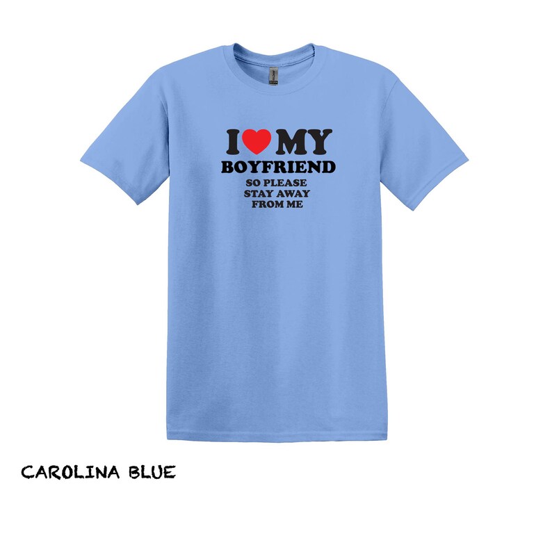 May include: Light blue t-shirt with a black graphic that says "I love my boyfriend so please stay away from me". The graphic includes a red heart.